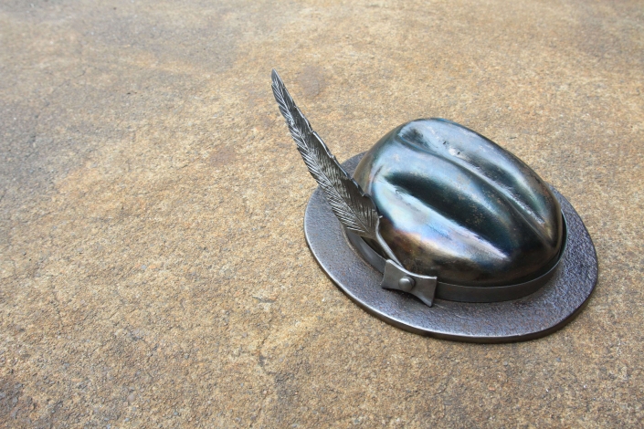 Fedora hat sculpture with feather