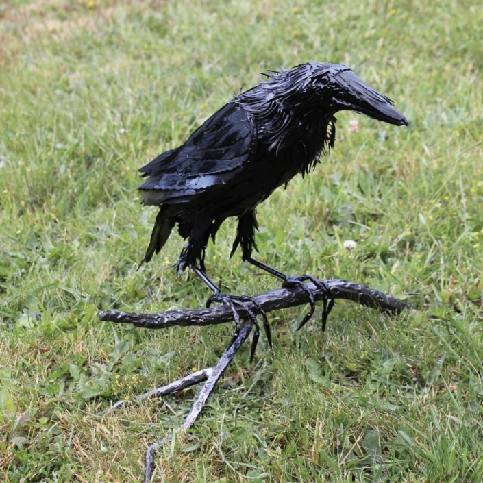 Metal raven on branch